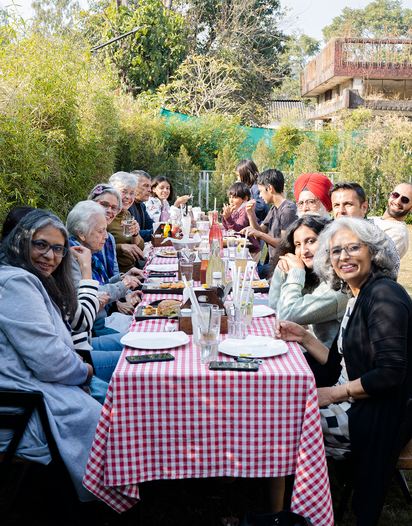 Otium Cookhouse interiors and garden — guests dining slowly amid warm light and greenery